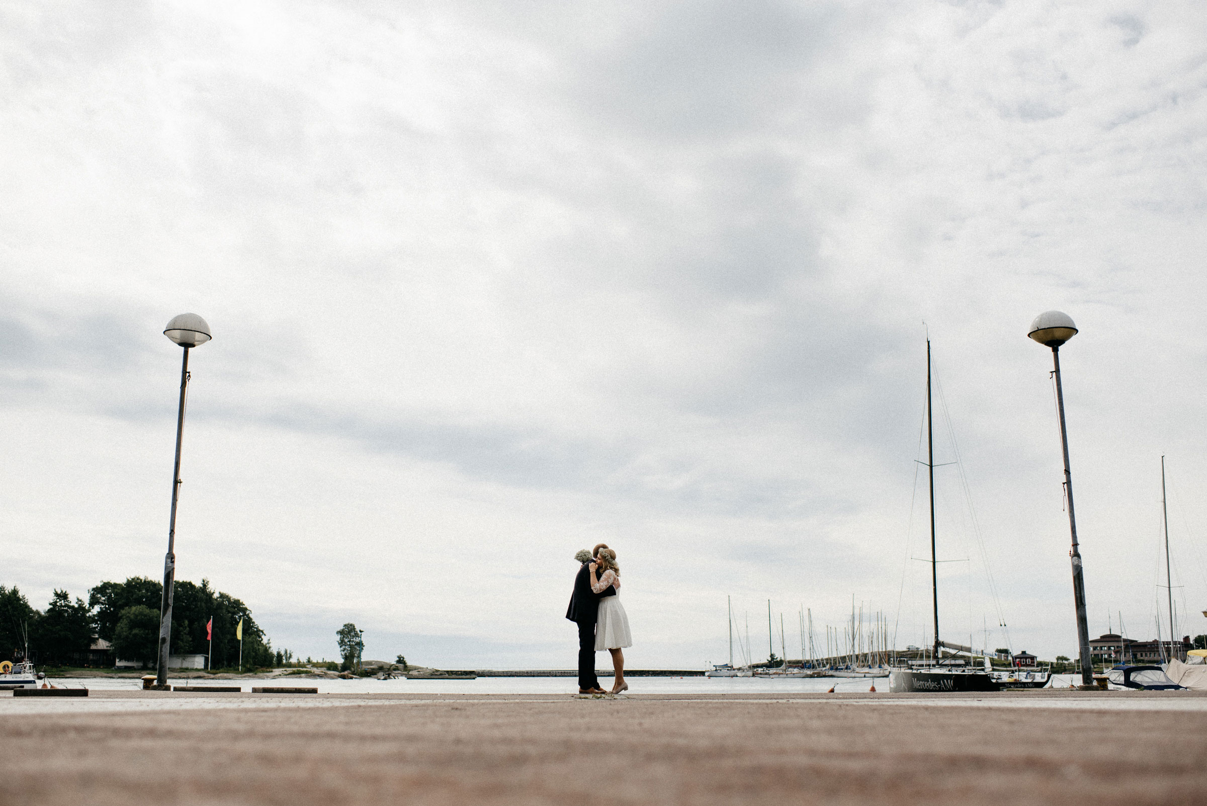 finnische Hochzeit: das Hochzeitspaar umarmt sich an der Promenade von Helsinki