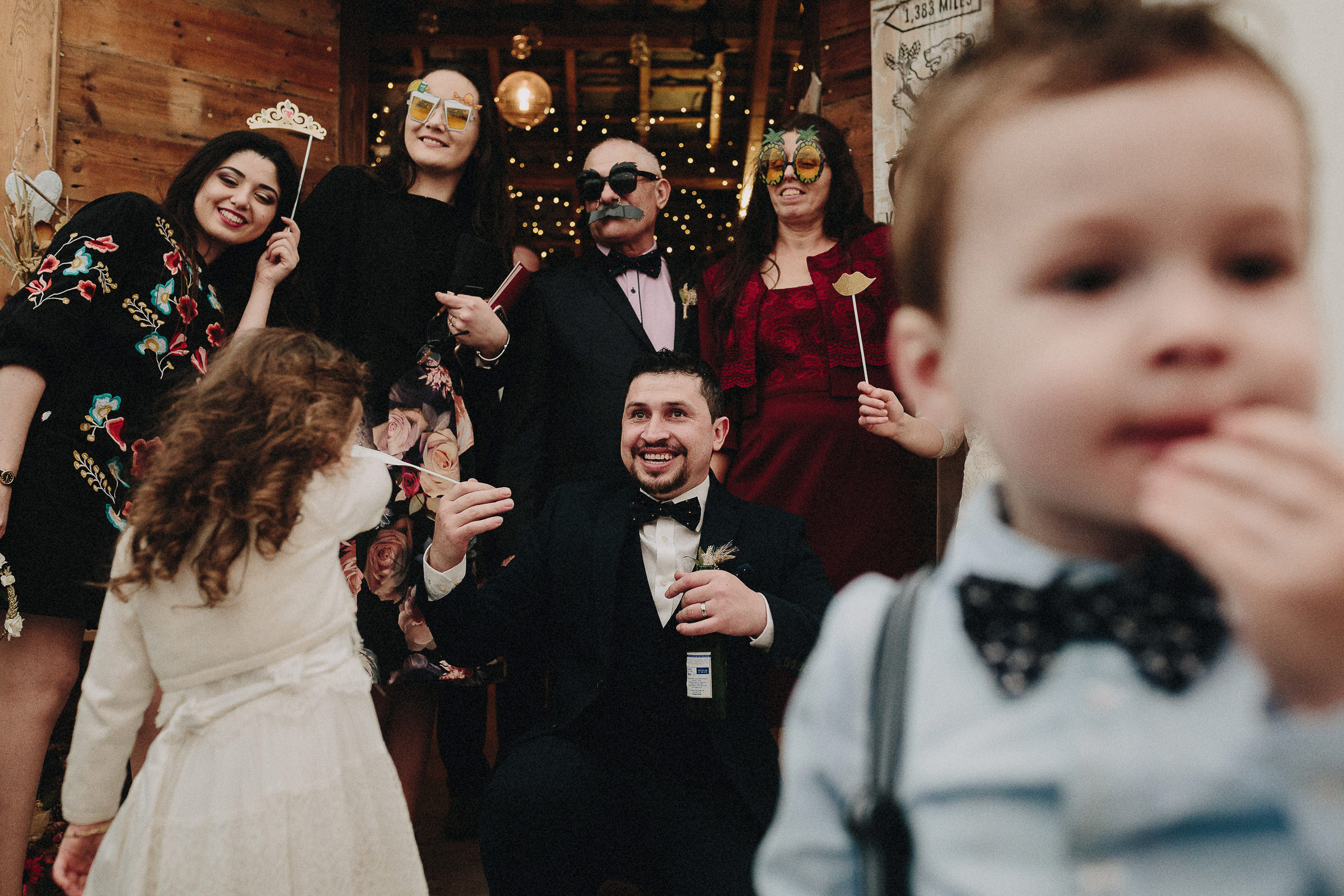 Britische Hochzeit: Hochzeitsgäste und Bräutigam vor Photobooth mit Party-Masken