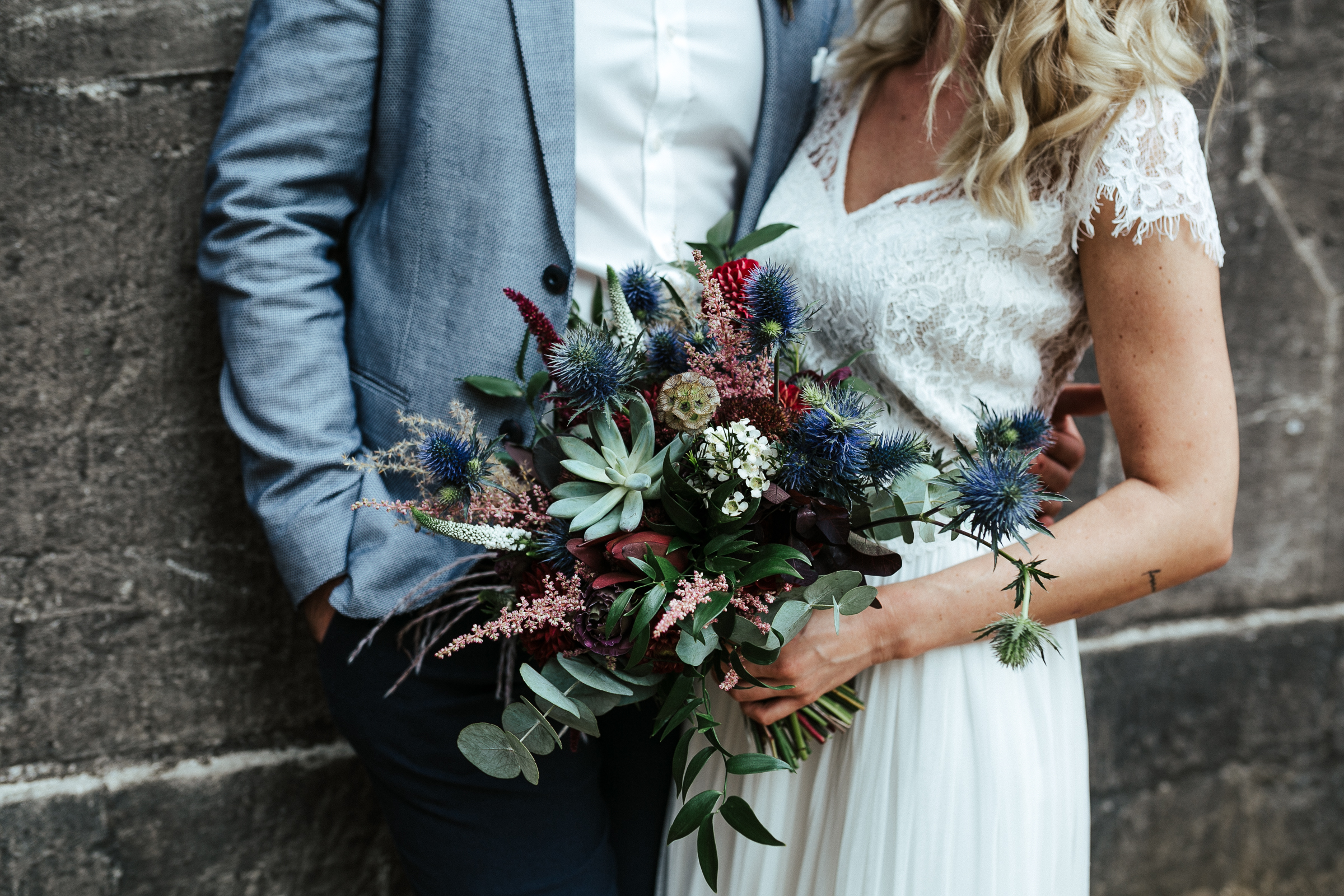Blumenschmuck von Kopflegenden: Brautpaar mit Brautstrauß